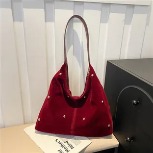 Vintage burgundy velvet shoulder bag with gold studs and brown leather strap