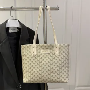 Chic beige monogram tote bag with dark grey M print and elegant shoulder straps