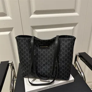Large capacity black tote bag with silver M pattern on a stylish leather seat