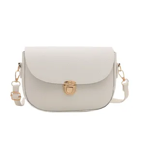 Chic white lychee textured saddle shoulder bag with gold hardware and leather strap