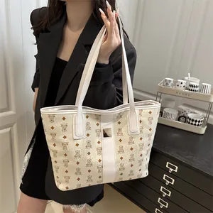 Chic cream tote bag with bear print and fine leather handles for daily commute