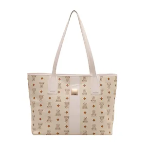 Chic beige tote bag with bear pattern and gold buckle for 2025 autumn fashion