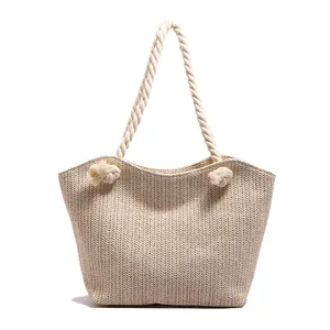 Minimalist beige woven straw tote bag with chunky cream rope handles for summer fashion