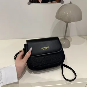Chic black saddle bag with houndstooth texture and adjustable strap for women