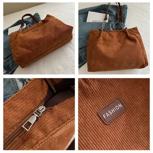 Detailansicht der braunen Cord-Tragetasche mit Lederriemen und Metallreißverschluss