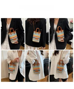 Mini multi-color striped woven crossbody bag with brown leather handles and shoulder strap