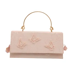 Pink rectangular handbag with 3D butterfly embroidery and golden metal handle
