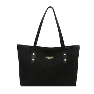 Large black striped tote bag with diamond texture and gold rivet leather handles