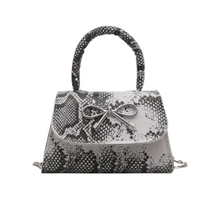 Retro snake pattern shoulder bag with magnetic flap and silver butterfly bow ornament