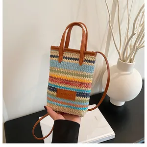 Detail of colorful woven mini tote bag with leather straps and fashion label