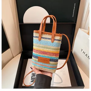 Close-up of colorful striped woven mini bag in elegant gift box with leather handles