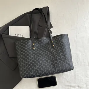 Large vintage black tote bag with M-letter monogram print and slim leather handles