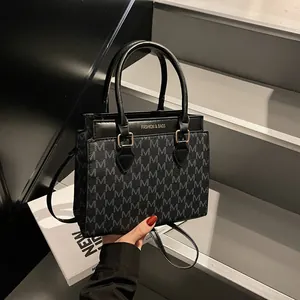 Fashion monogram tote bag in black leather with shoulder strap and gold lettering