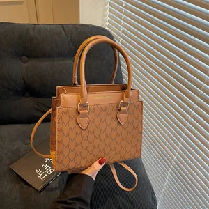 Classic brown monogram tote bag with double handles and shoulder strap for women