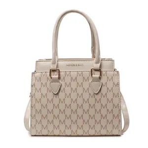 Elegant beige tote bag with M-monogram pattern and gold-tone handles for women