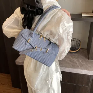 Light blue woven texture pillow bag with long handles and gold hardware buckle