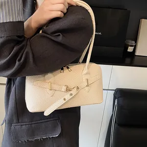 Beige woven rectangular pillow bag with metal buckle cross-strap and gold zipper details