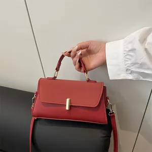 Sac à main classique en cuir mat rouge avec détails dorés et bandoulière réglable
