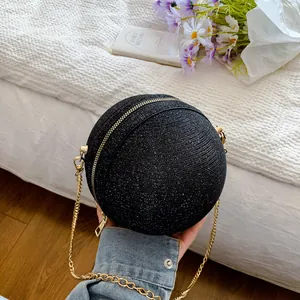 Sparkly black spherical clutch bag with golden metal chain strap and shimmer finish