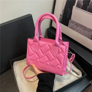 Pink quilted PU leather crossbody bag with top handles and fashion text on black box