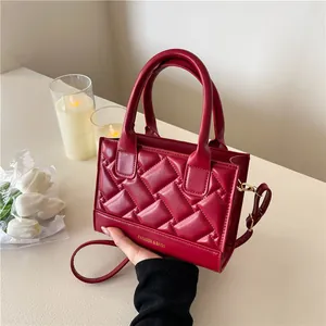Quilted deep red PU leather handbag with gold lettering and detachable shoulder strap