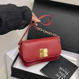Elegant red flap shoulder bag with gold square buckle and chain strap on classic background