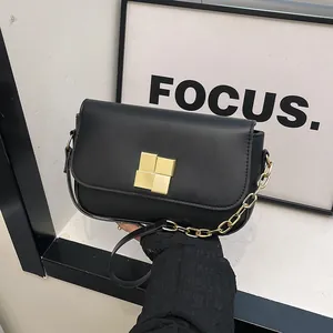 Elegant black leather square shoulder bag with gold geometric clasp and chain strap