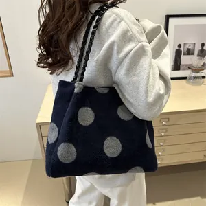 Blue plush tote bag with grey polka dots and stylish black woven shoulder straps