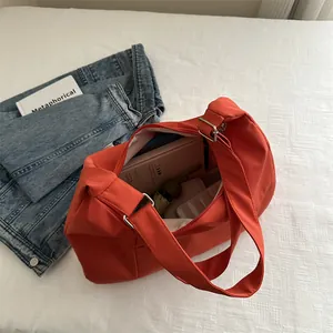 Large burnt orange canvas tote bag with adjustable strap for daily commute or travel