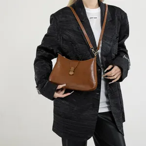 Retro dark brown crescent shoulder bag for women with vintage metal buckle and adjustable strap
