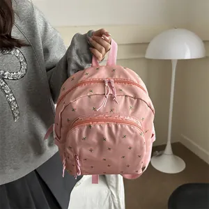 Pink floral embroidered mini backpack in waterproof nylon with multiple pockets