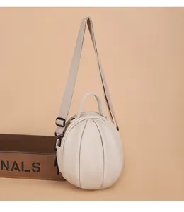 Detailed macro view of beige lychee grain PU leather pumpkin bag with adjustable strap