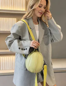 Model showing a light yellow lychee pattern sphere-shaped PU leather crossbody bag