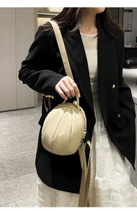 Close-up of beige lychee texture mini backpack showing the spherical multi-faceted design