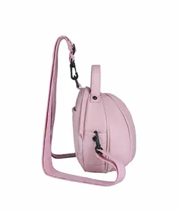 Side view of pink basketball-shaped cross-body bag with litchi grain texture