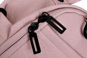Detail of pink lychee leather texture with dual black metal rectangular zippers