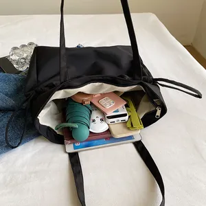 Black large capacity lightweight canvas tote bag with spacious interior for daily commute