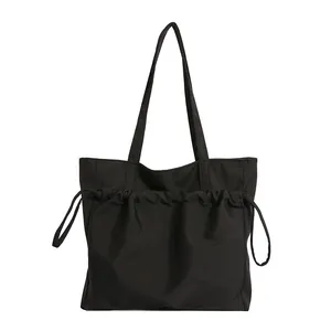 Minimalist black lightweight canvas tote bag with drawstring pocket and large capacity