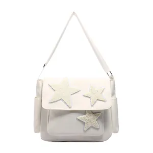 Japanese style white messenger bag with plush star patches and adjustable shoulder strap