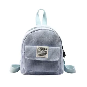Mini light blue corduroy backpack featuring a front pocket and adjustable straps