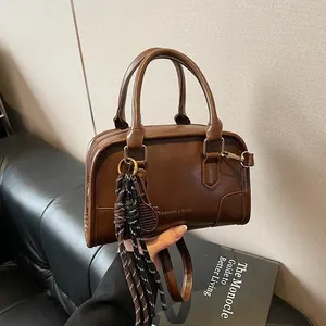 Classic dark brown leather Boston bag with fashion logo and tennis racket charm
