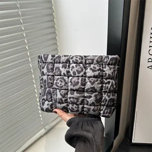 Fashionable leopard print quilted pouch held in hand for a stylish spring look