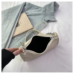 Top view of beige woven handbag interior showing black lining and silver zipper detail