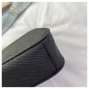 Detailed macro view showing the textured woven material and stitching of the dark grey bag
