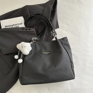 Chic black textured tote bag with chain strap and cute white plush cloud charm