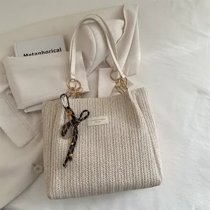 Chic cream woven straw tote bag with letter patch and decorative tennis racket charm