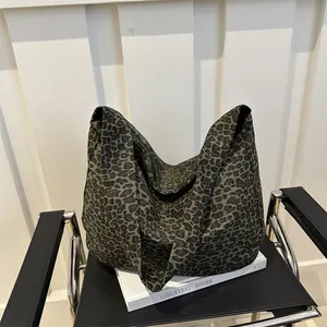 Leopard print canvas tote bag with large capacity and hobo style on modern chair