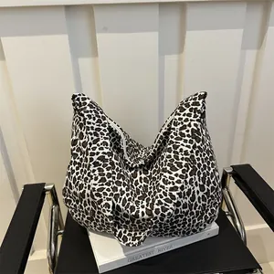 Large leopard print canvas tote bag for women placed on a magazine for a stylish look