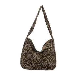 Minimalist leopard print canvas hobo bag with zip closure and wide shoulder strap