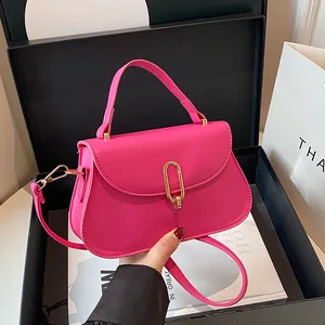 Vibrant rose pink crossbody handbag with golden U-shaped lock on luxury gift box set